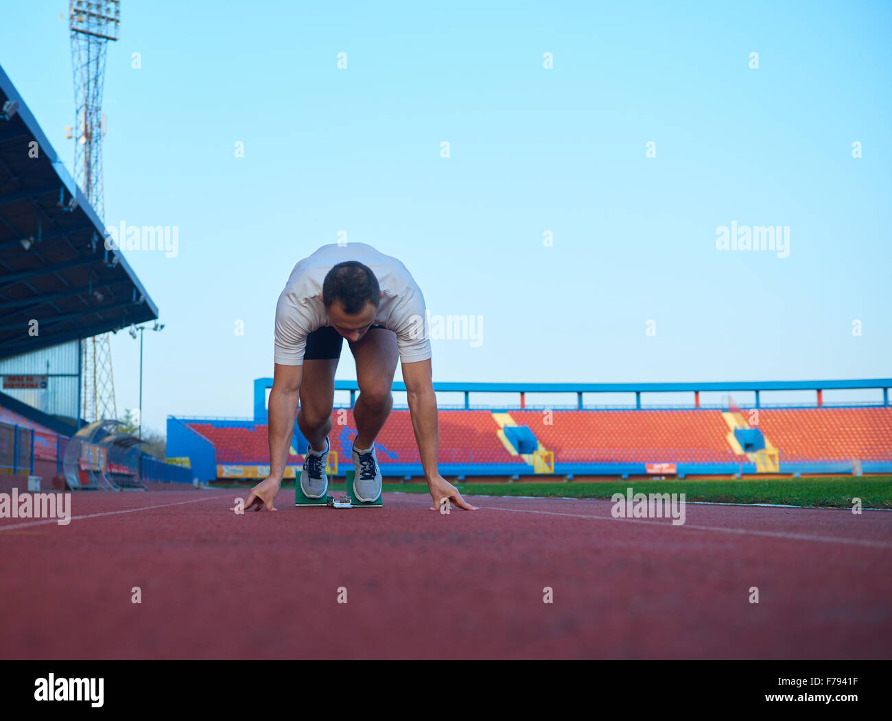 Sprinter leaving starting blocks on the running track. Explosive start ...