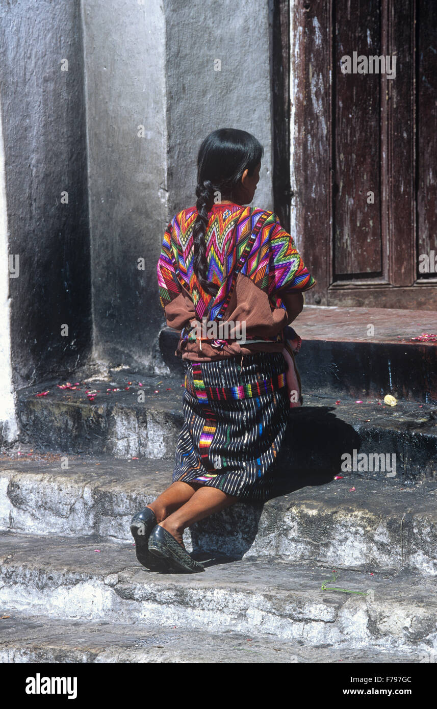 Indian woman kneels in prayer at El Calvario Chapel, Chichicastenango, Guatemala. Stock Photo