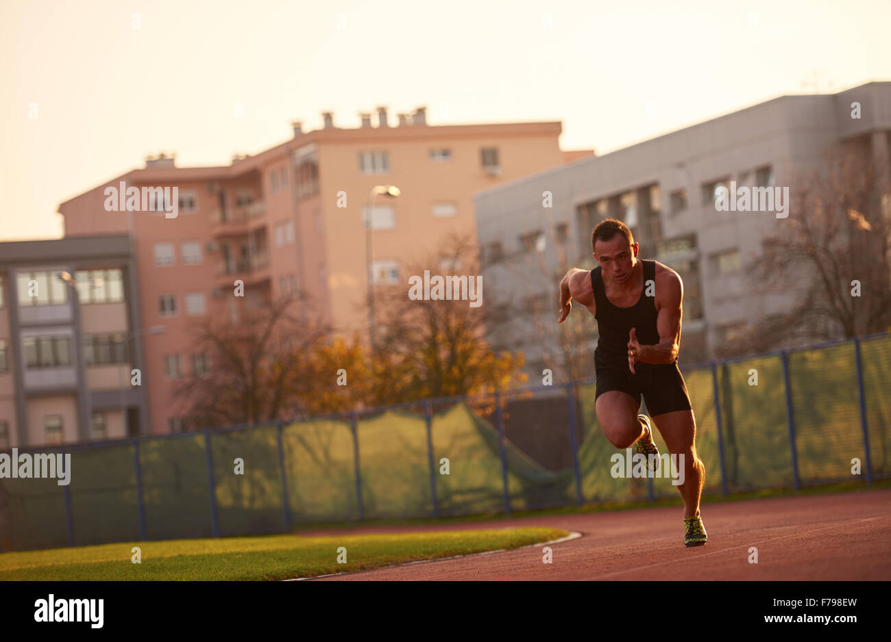 Sprinter leaving starting blocks on the running track. Explosive start ...