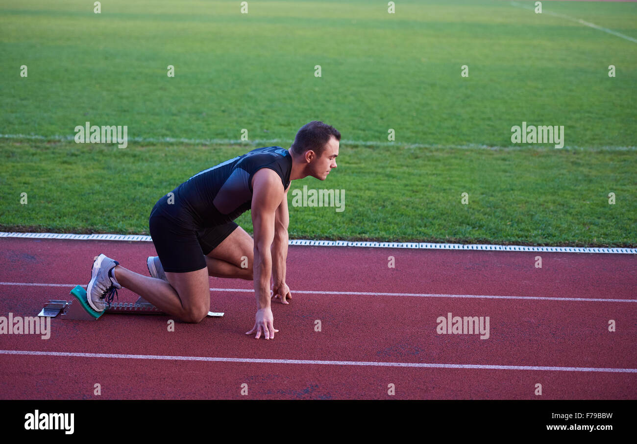 Sprinter leaving starting blocks on the running track. Explosive start ...