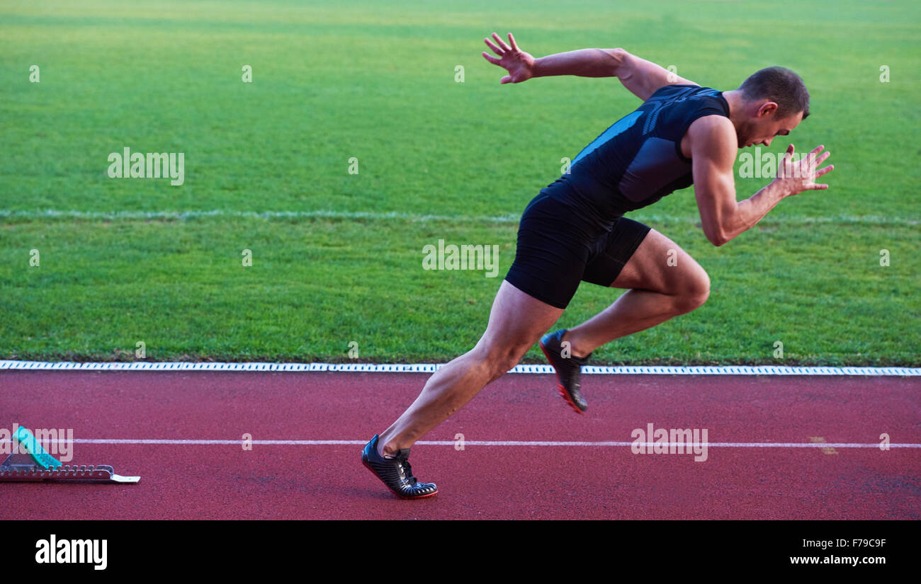 Sprinter leaving starting blocks on the running track. Explosive start ...