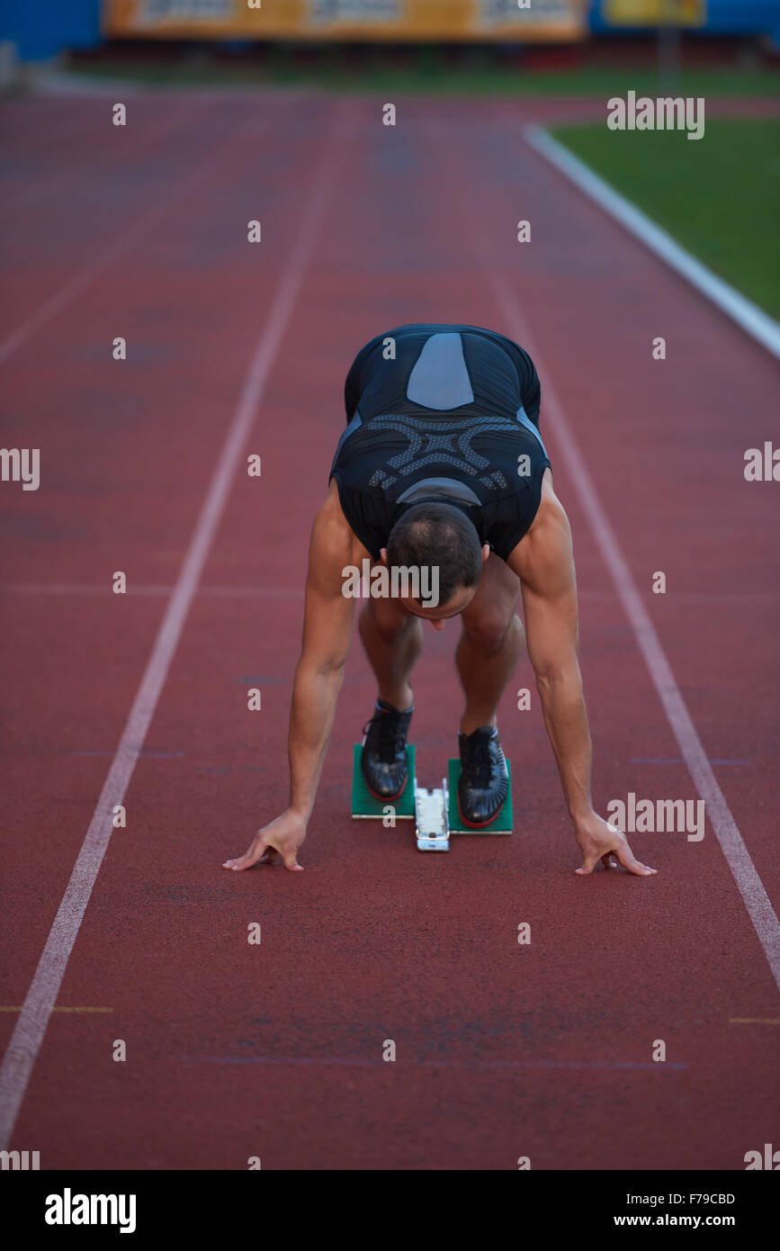 Sprinter leaving starting blocks on the running track. Explosive start ...