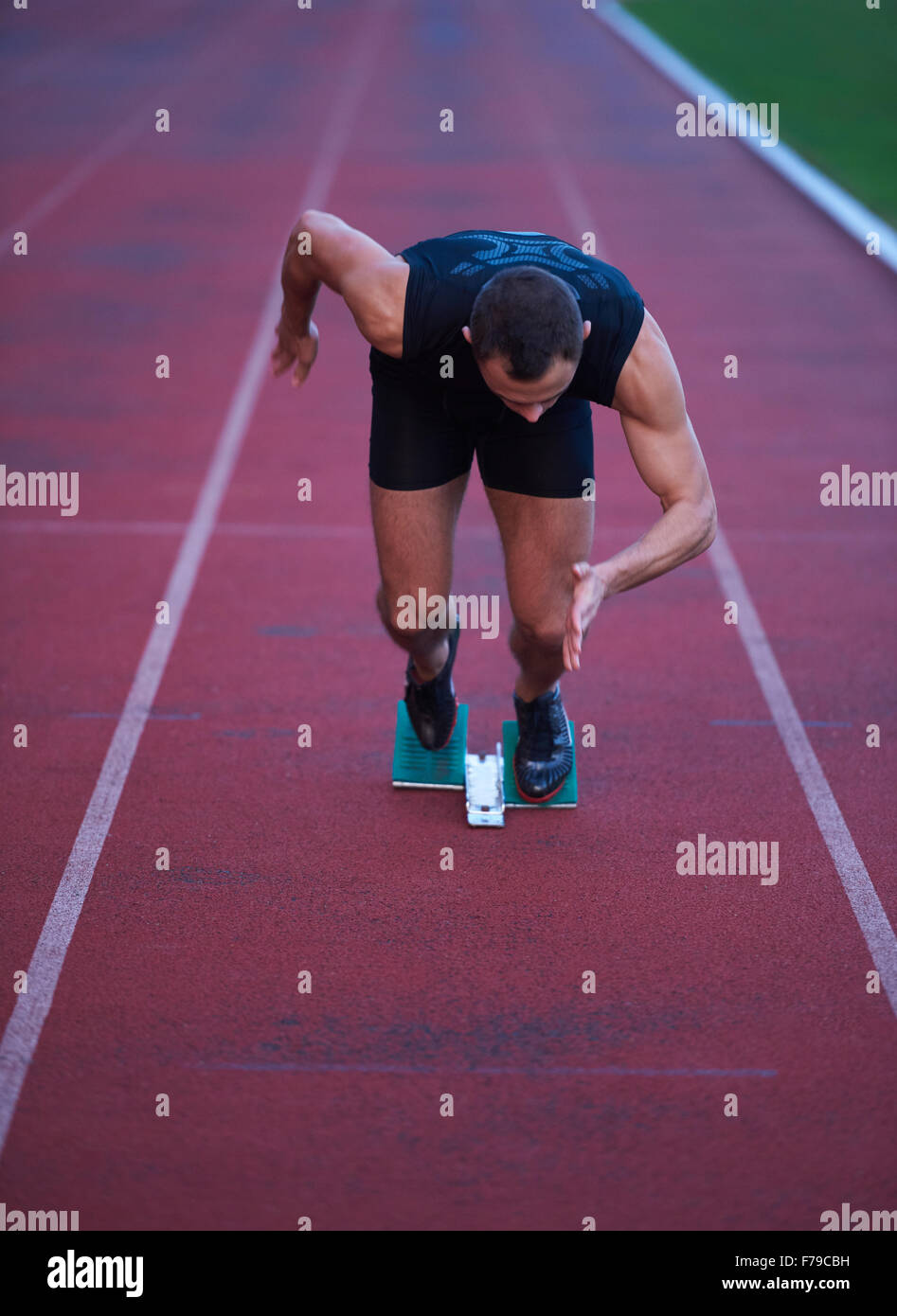 Sprinter leaving starting blocks on the running track. Explosive start ...