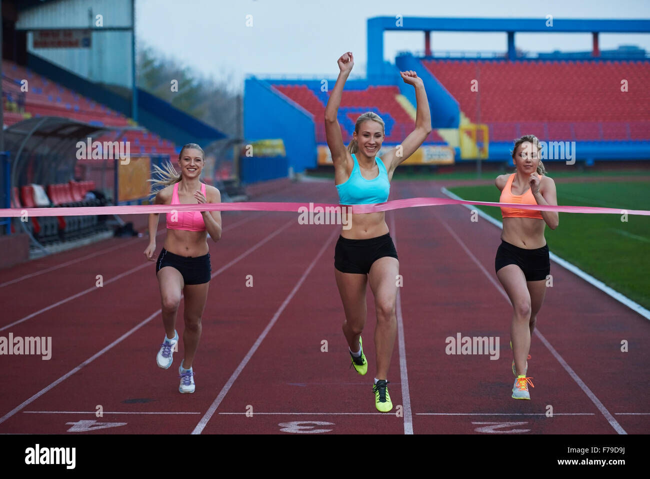 Female Runners Finishing athletic Race Together Stock Photo - Alamy