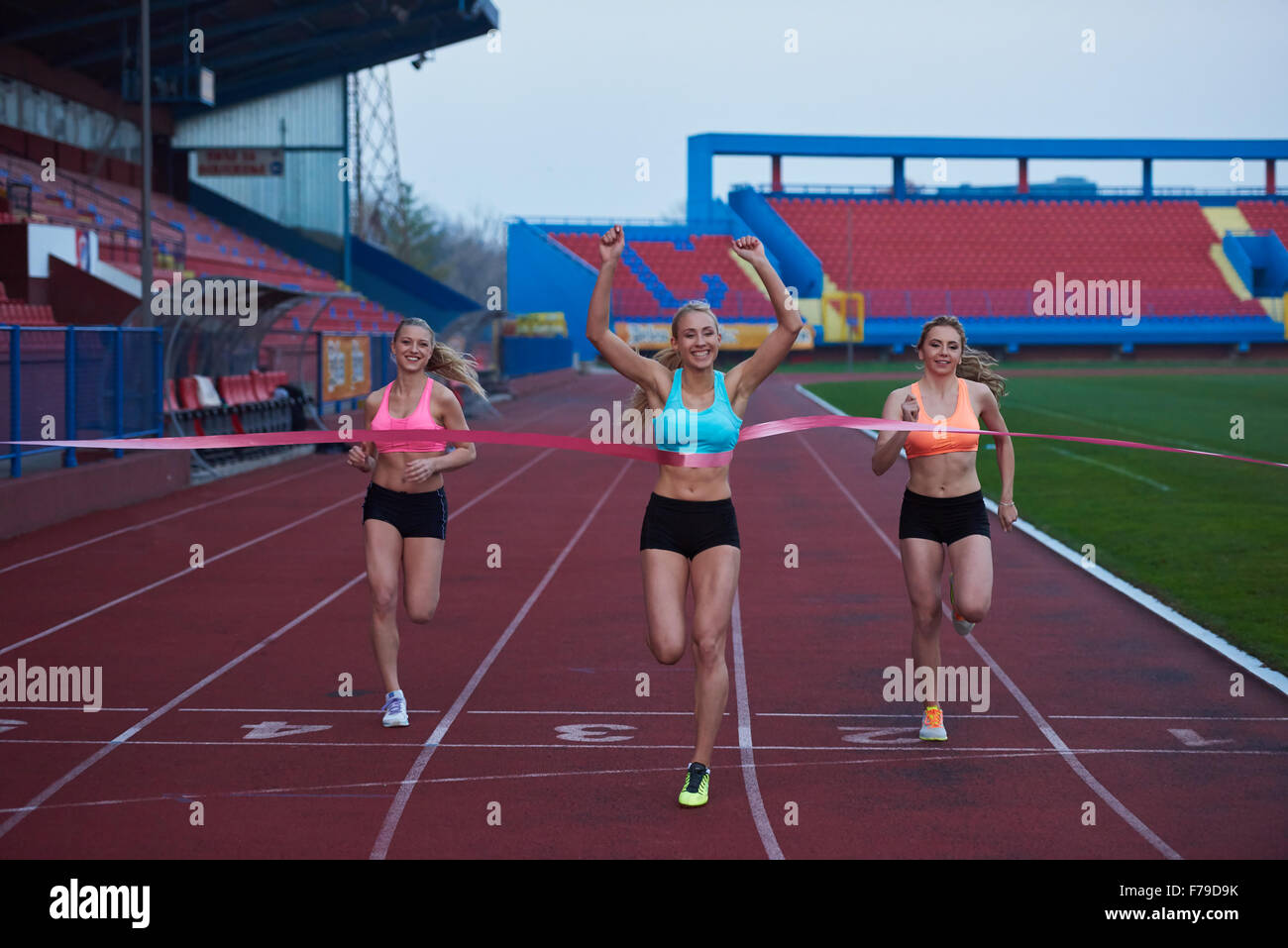 Female Runners Finishing athletic Race Together Stock Photo - Alamy
