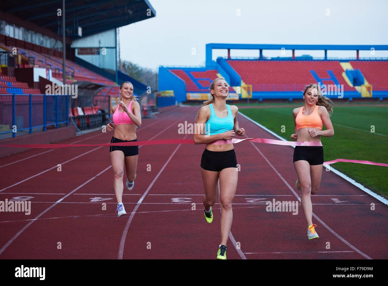 Female Runners Finishing athletic Race Together Stock Photo - Alamy