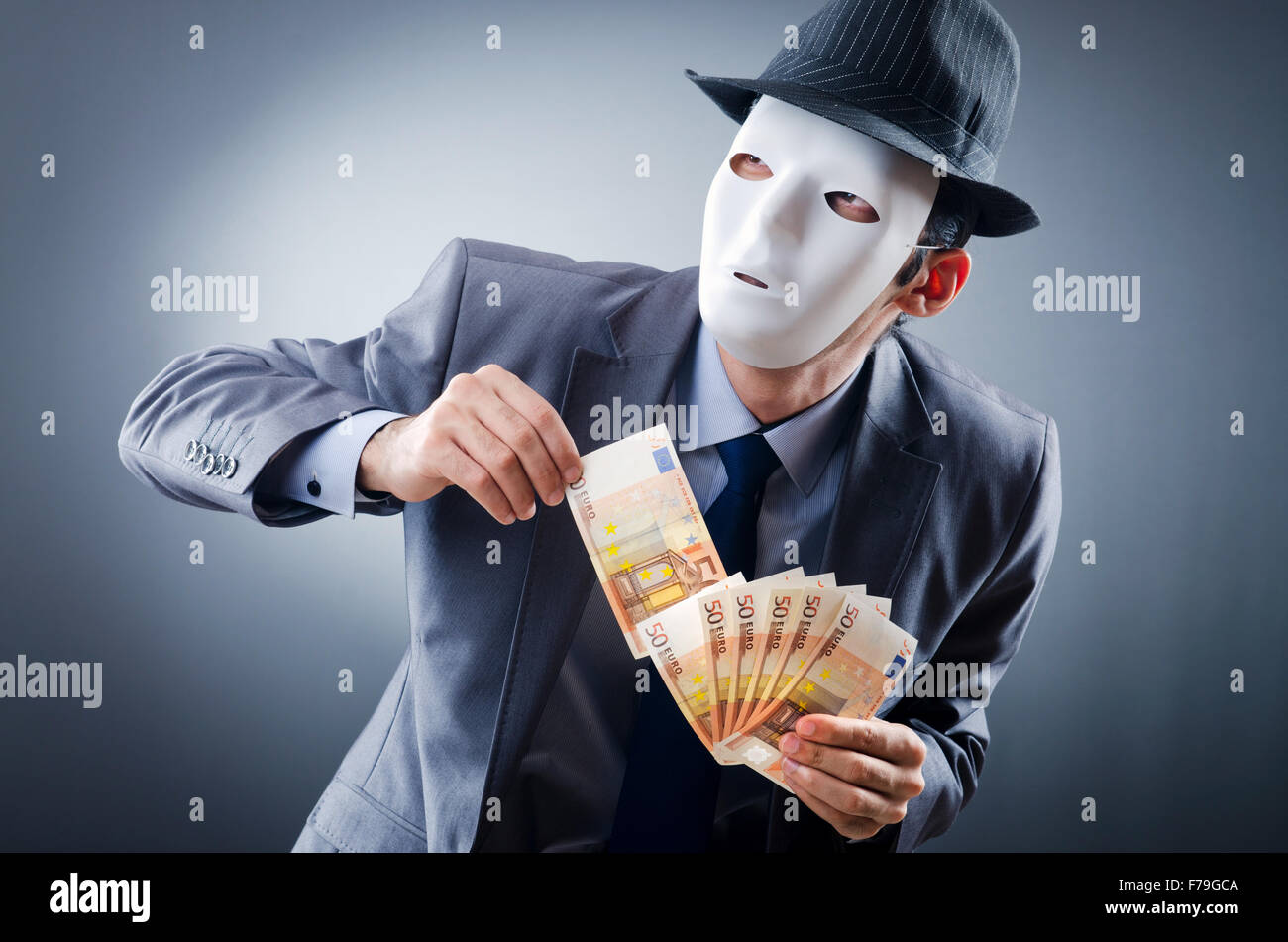 Businessman with money and mask Stock Photo - Alamy