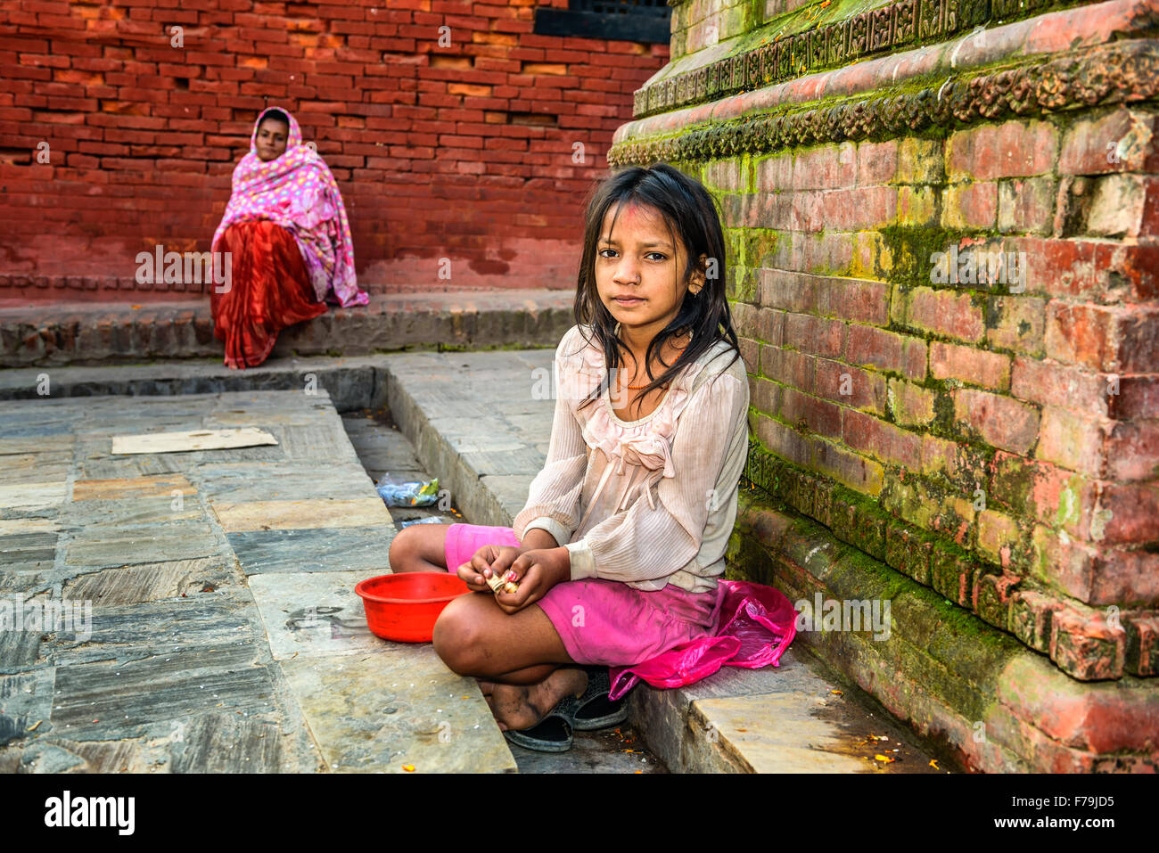 Young girl begging for alms at Pashupatinath Temple complex in Kathmandu Stock Photo