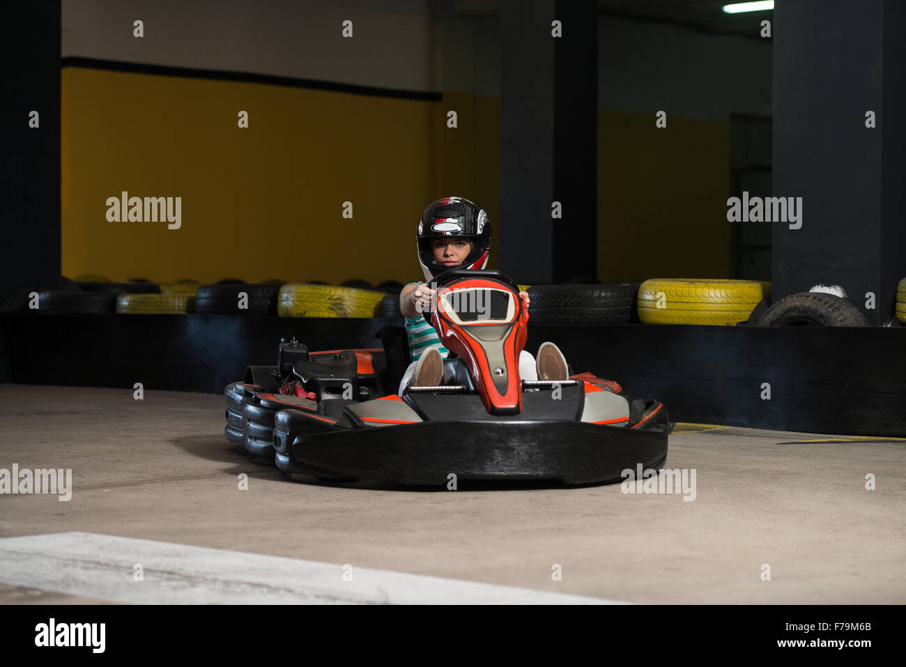 Young Woman Is Driving GoKart Car With Speed In A Playground Racing