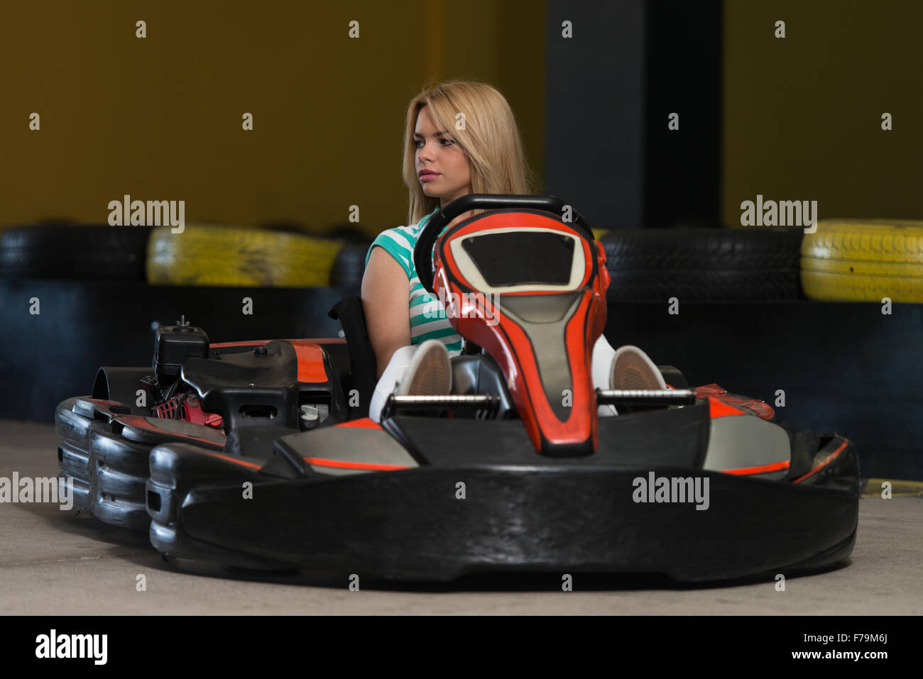 Young Woman Is Driving GoKart Car With Speed In A Playground Racing