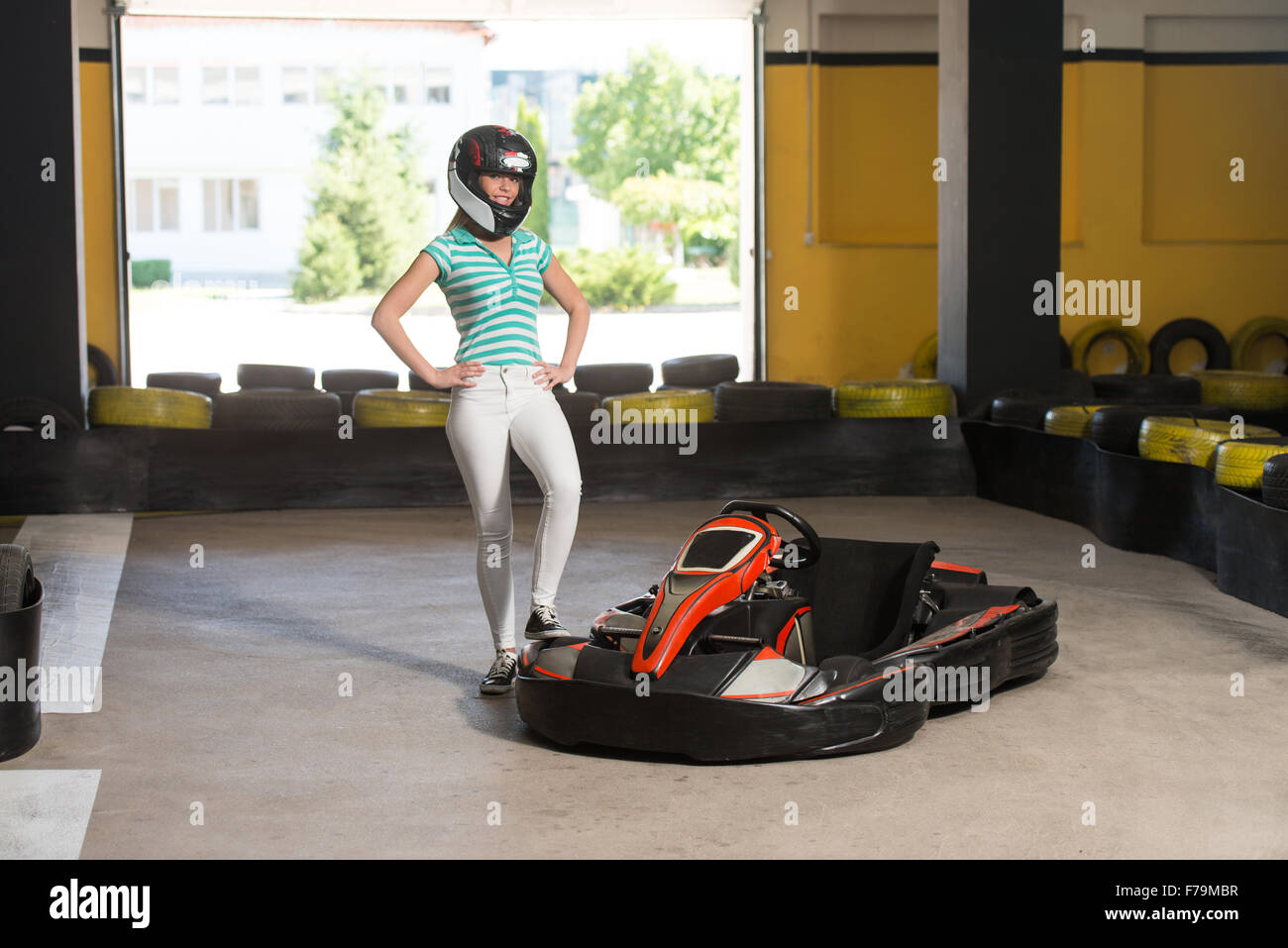 Young Woman Is Driving GoKart Car With Speed In A Playground Racing