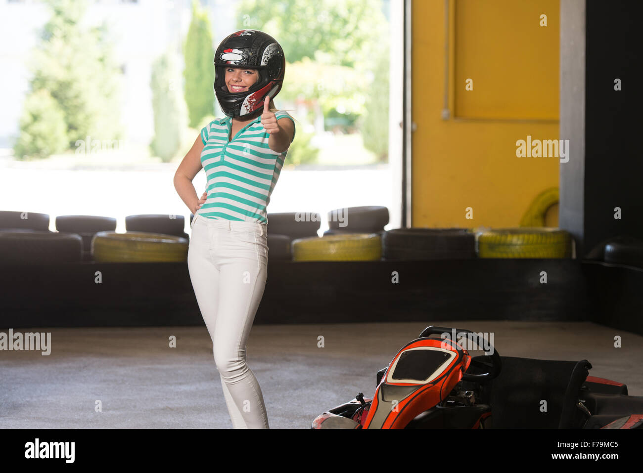 Young Woman Showing Thumbs Up For Karting Race Stock Photo