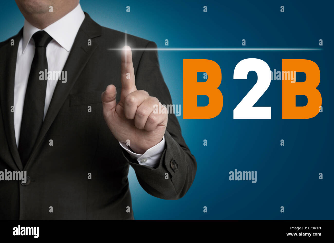 B2B touchscreen is operated by businessman concept. Stock Photo