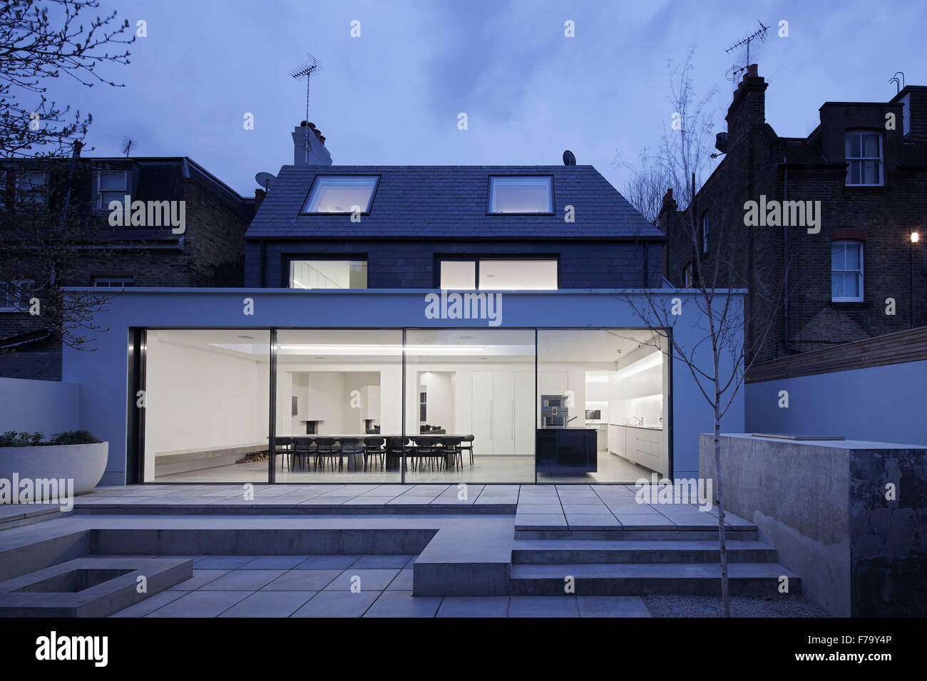 View from garden of kitchen extension in modern family home at night 2013, design by Found Associates Stock Photo