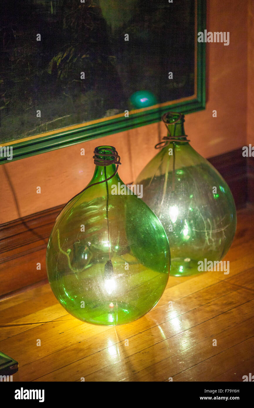 Two glass green bottle lamps in home of Designer Erica Pols, Australia Stock Photo