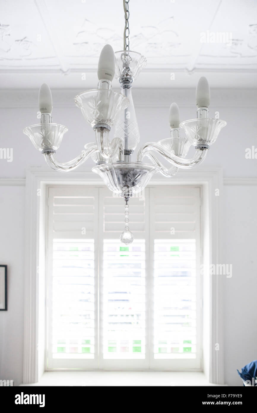 Murano glass light fitting and window shutters in Sydney home of designer and Heritage Consultant Janine Hendry. Stock Photo