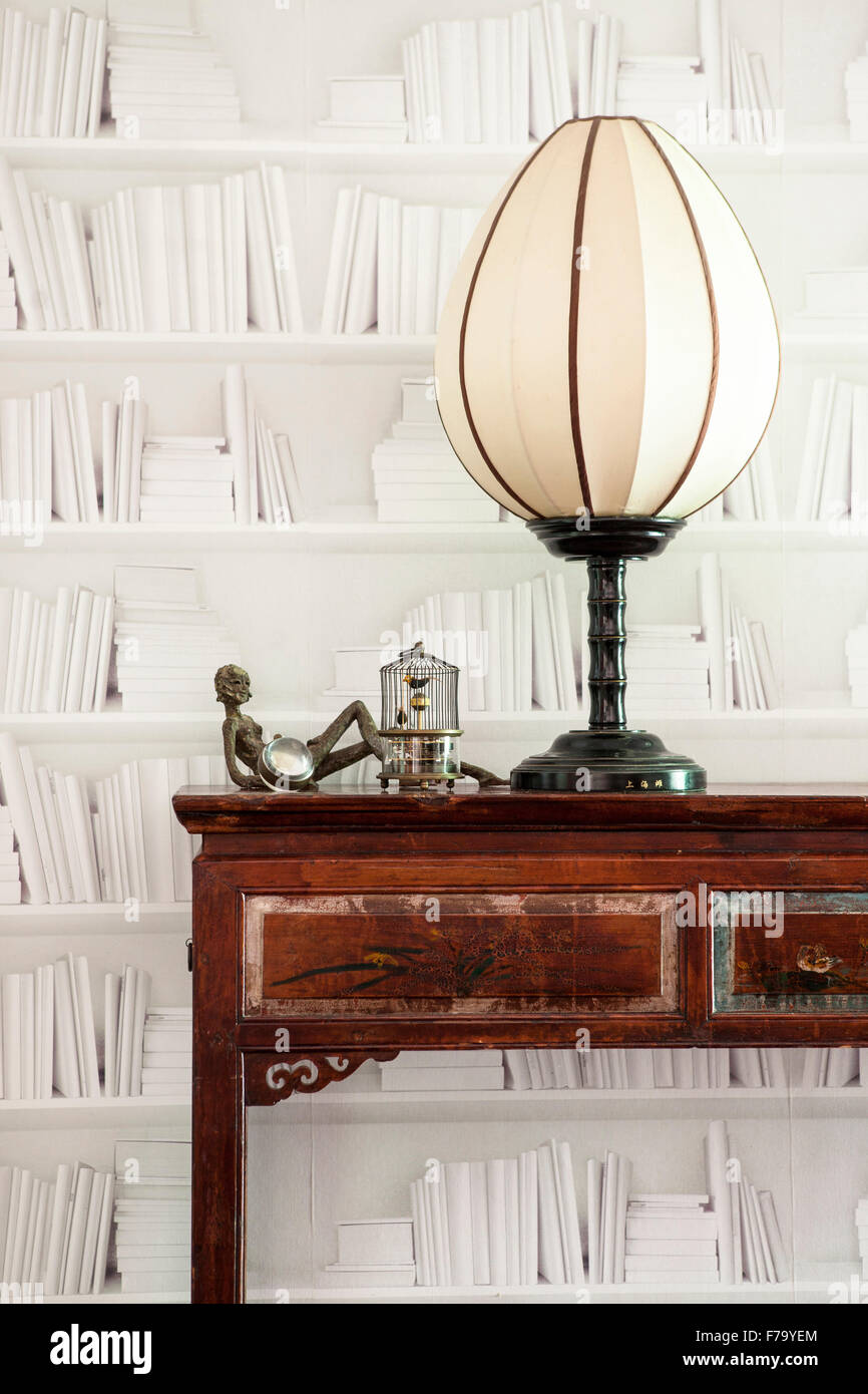 Vintage lamp and book wallpaper in Sydney home of designer and Heritage Consultant Janine Hendry. Stock Photo