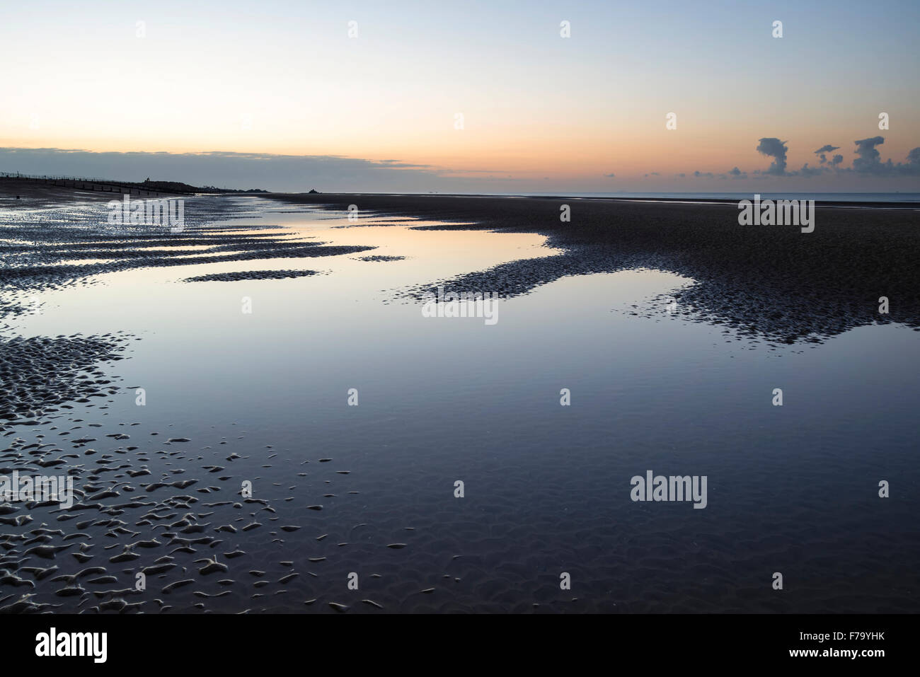 Beautiful calm sunrise over low tide beach Stock Photo - Alamy