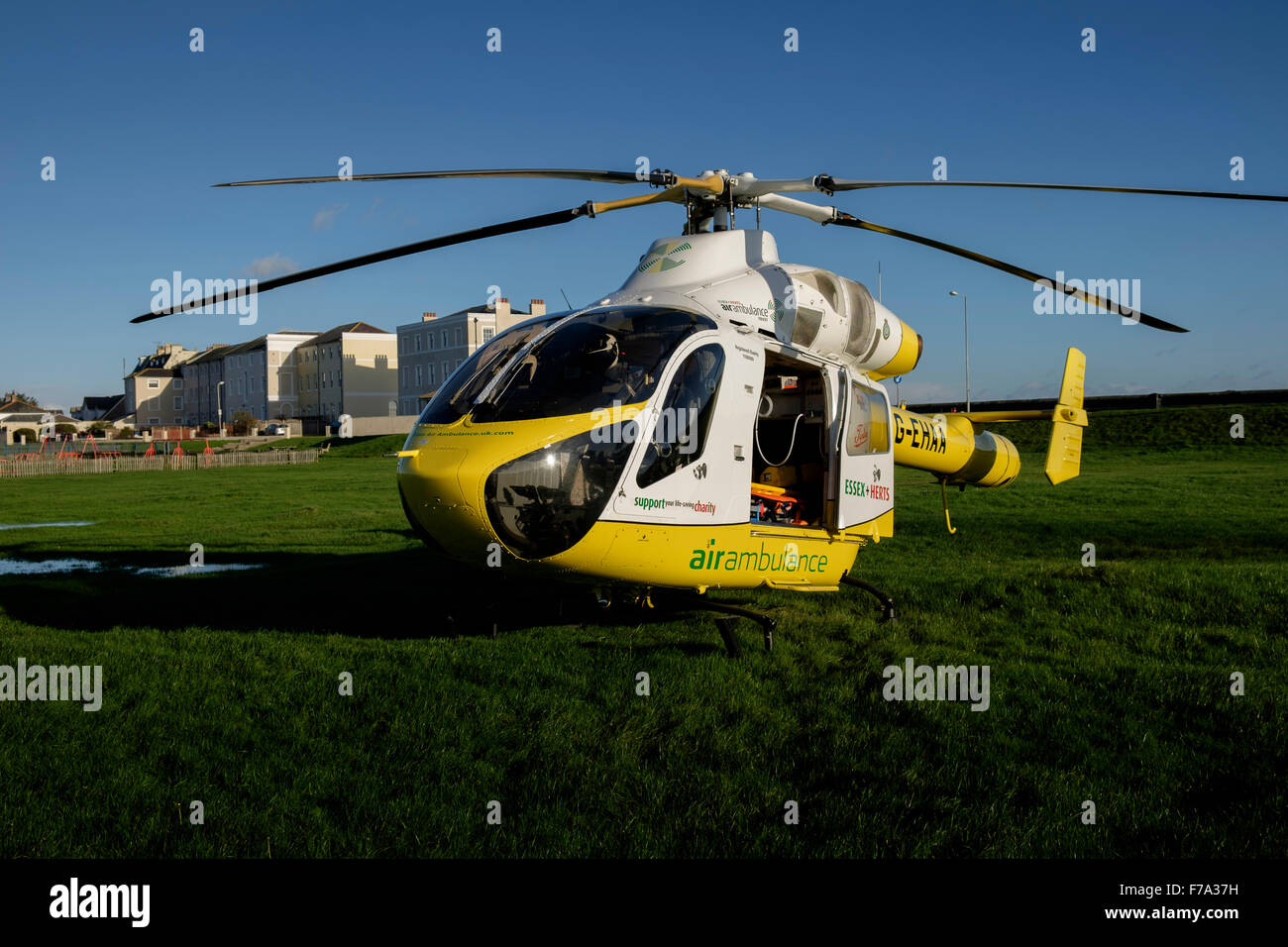 Essex and Herts air ambulance trust helicopter at bathhouse meadow Walton on the Naze Stock Photo