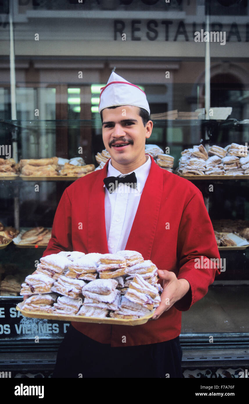 A waiter displays the famous pastries of La Bombonera in Old Town, San Juan, Puerto Rico Stock Photo