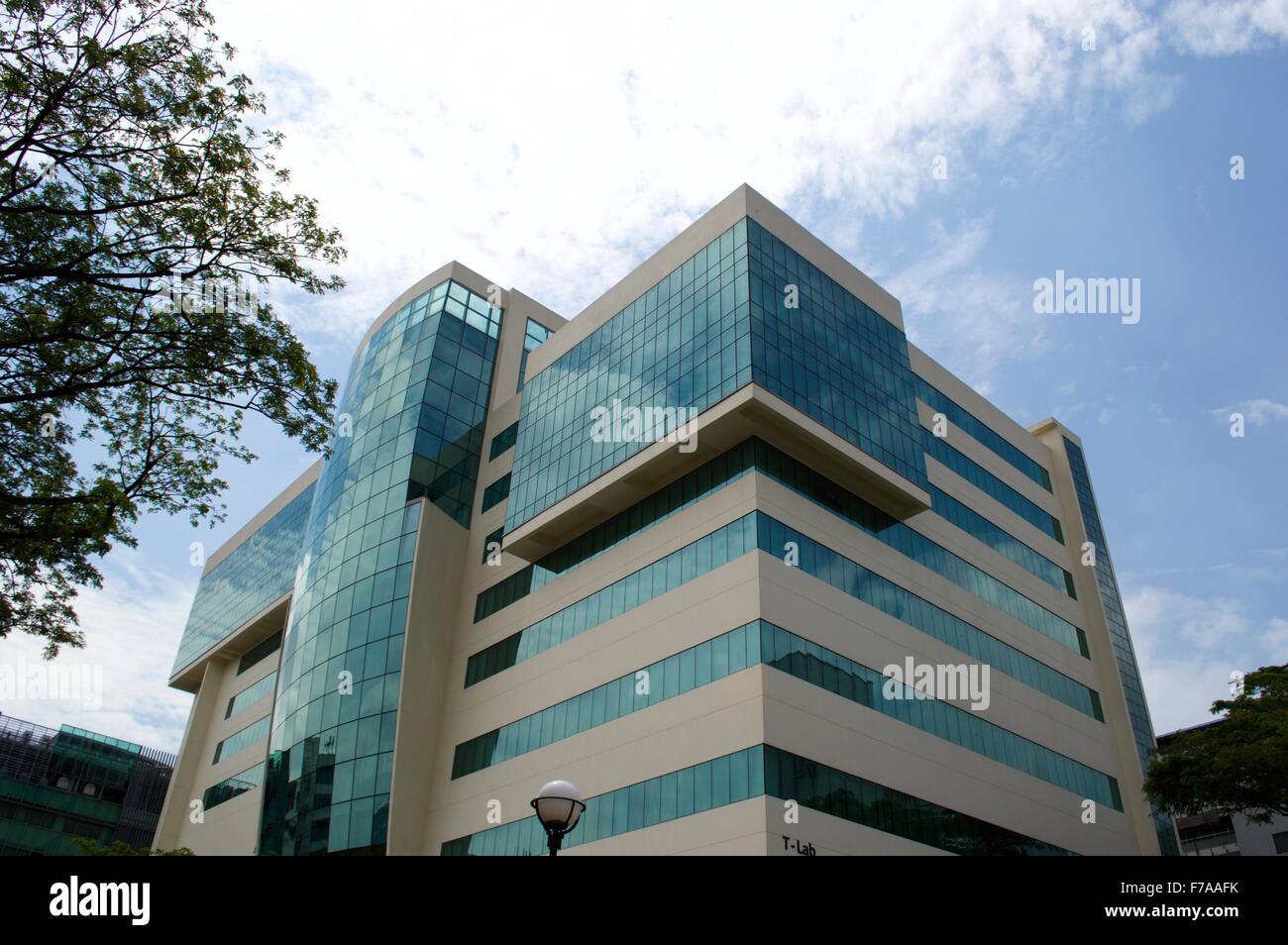 A multistory singapore university building and blue sky in the background Stock Photo