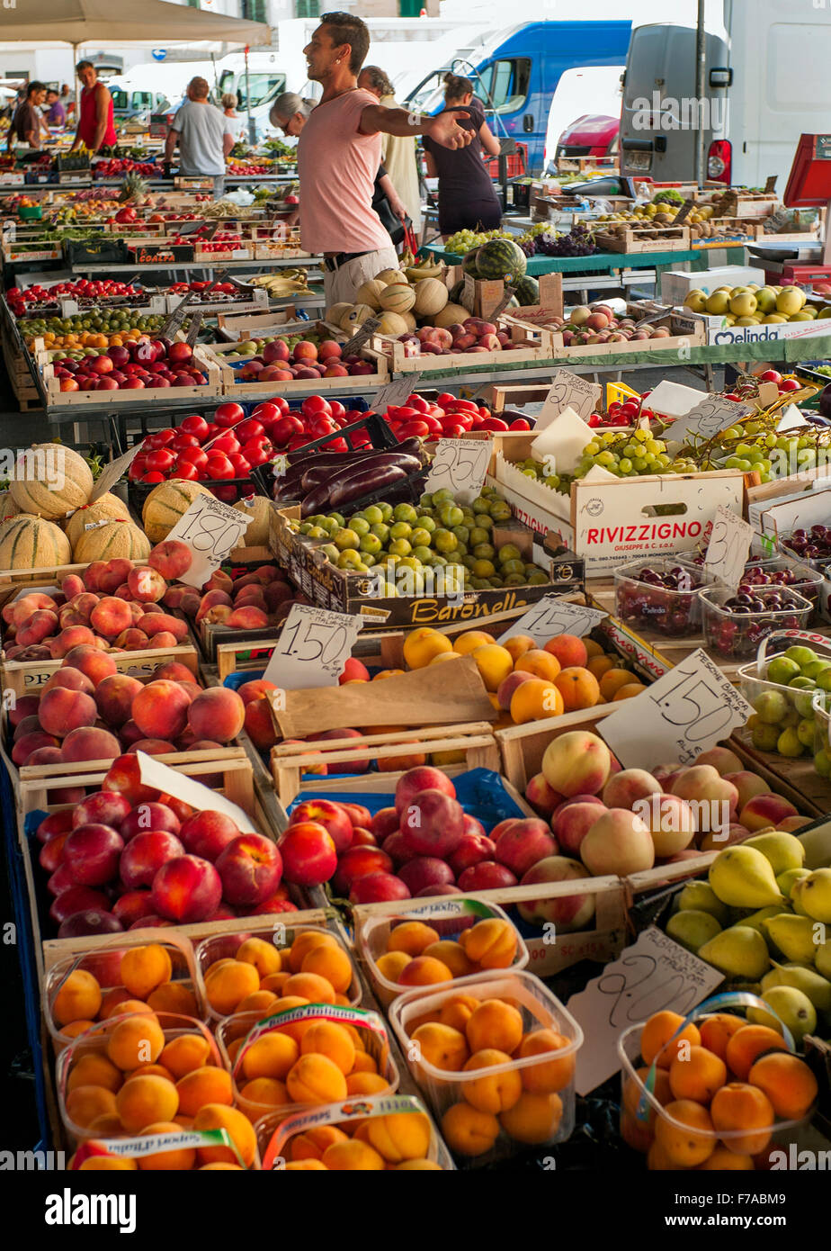 Market holder stretches while selling fruit in  Market Sant'Ambrogio Mercato Sant' Ambrogio Florence, Italy Stock Photo