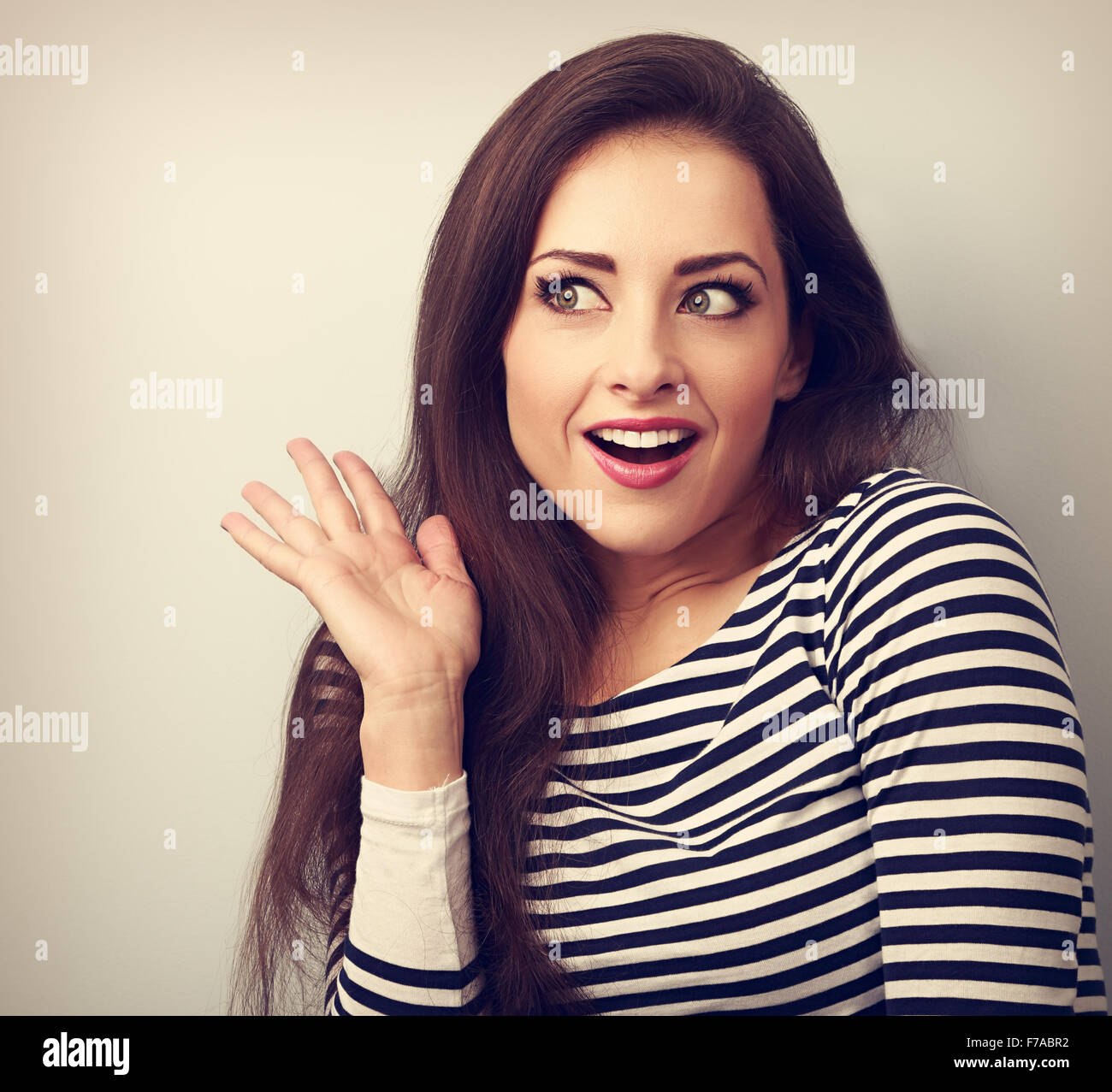 Excited beautiful woman surprising and looking. Woman with open mouth and gesturing hand. Closeup vintage portrait Stock Photo