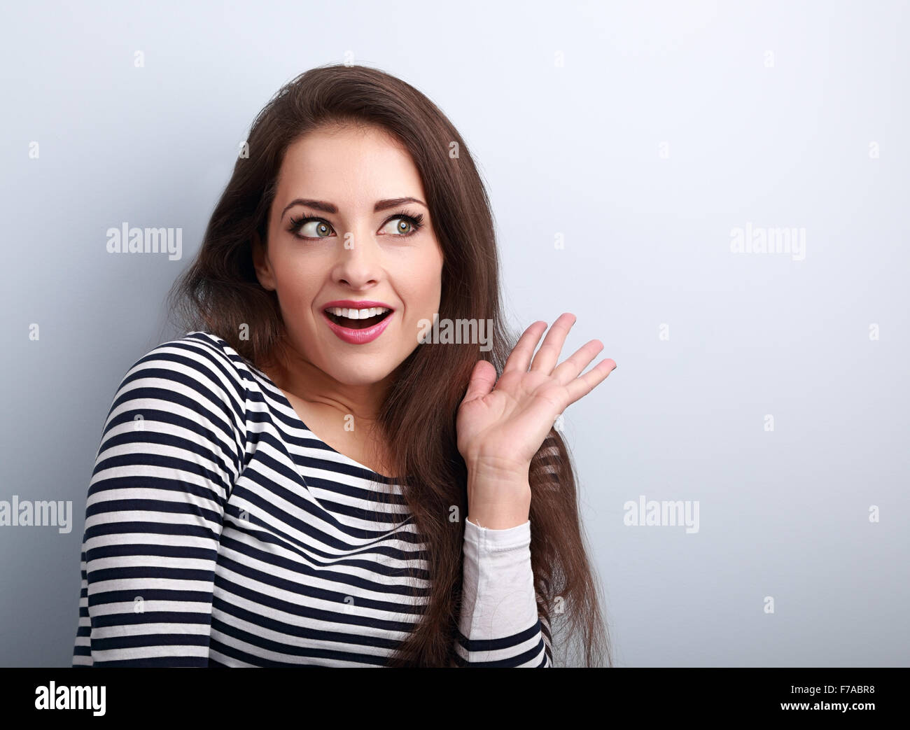 Excited beautiful woman surprising and looking. Woman with open mouth and gesturing hand. Closeup portrait Stock Photo
