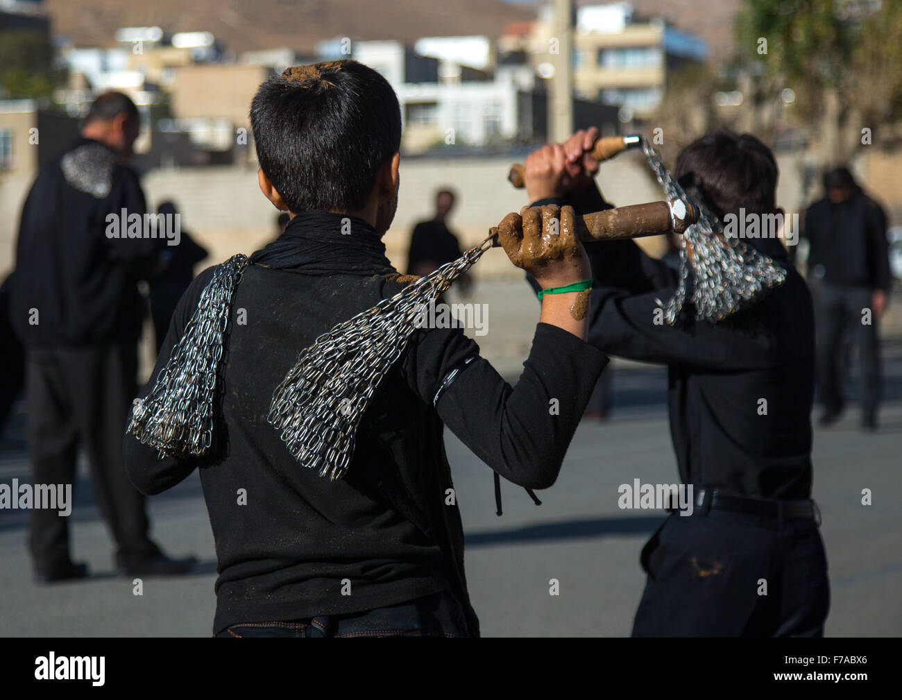 Iranian Shiite Boys Covered In Mud Are Beating Themselves With Iron Chains To Commemorate Ashura, The Day Of The Death Of Imam Hussein, Kurdistan Province, Bijar, Iran Stock Photo