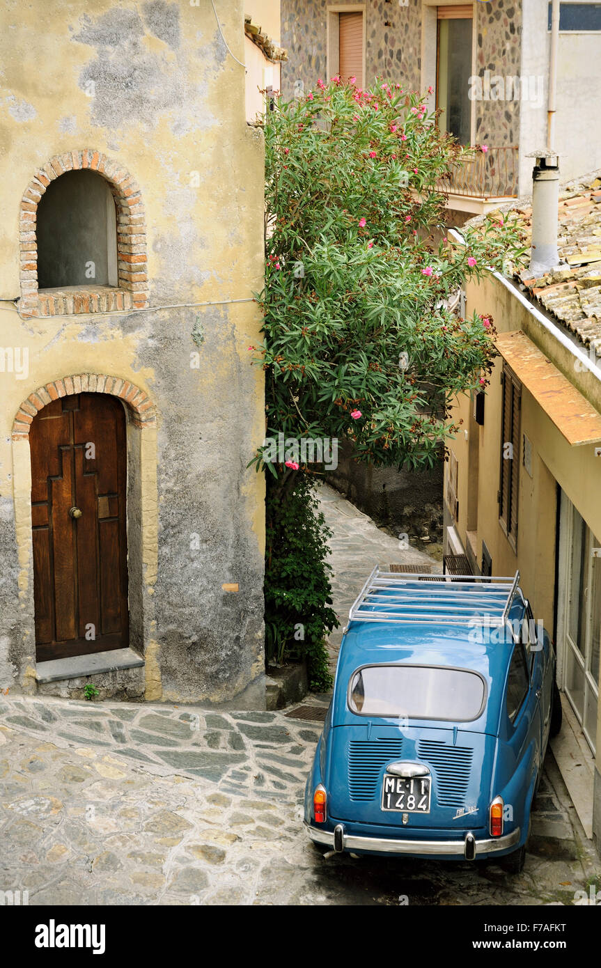 Old blue Fiat 600 parked in a narrow street of Castelmola, Sicily, Italy Stock Photo