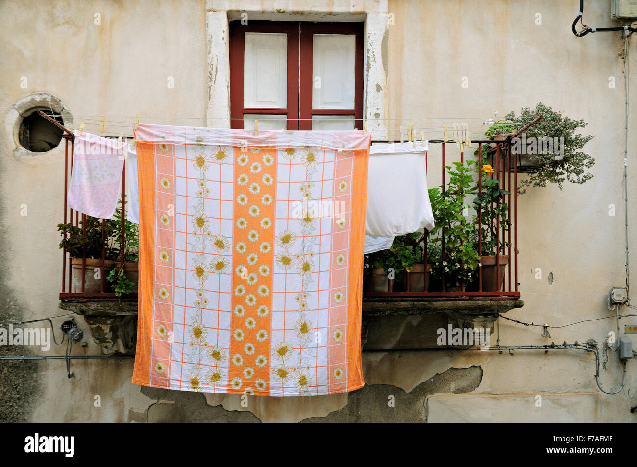 Laundry hanging on a balcony in Forza d'Agrò, Sicily, Italy Stock Photo