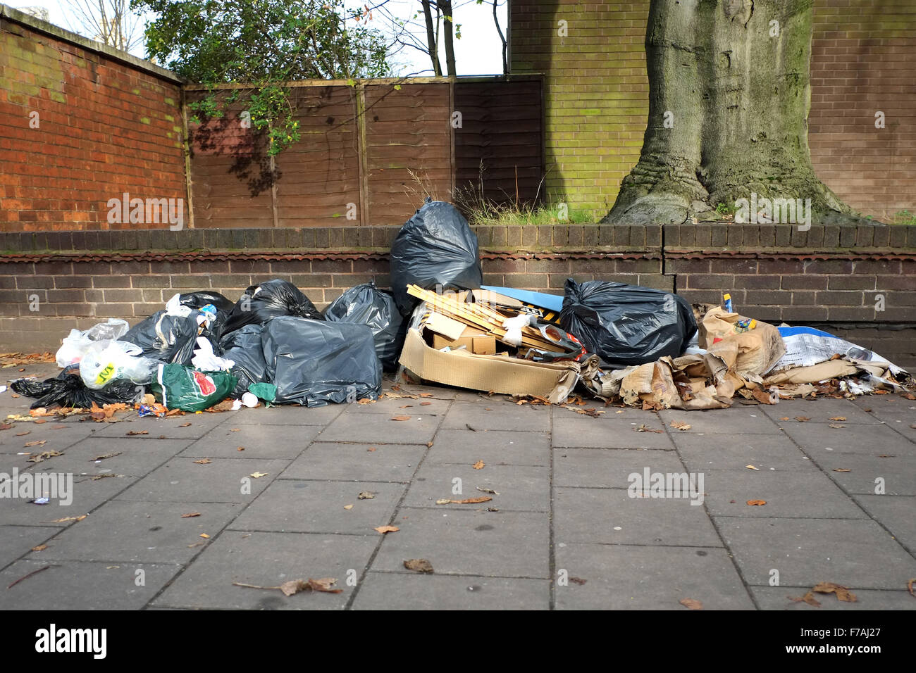 Refuse and rubbish left on a UK city center street. The rubbish, in bin bags and discarded boxes, is an eyesore and unhygienic health hazard Stock Photo