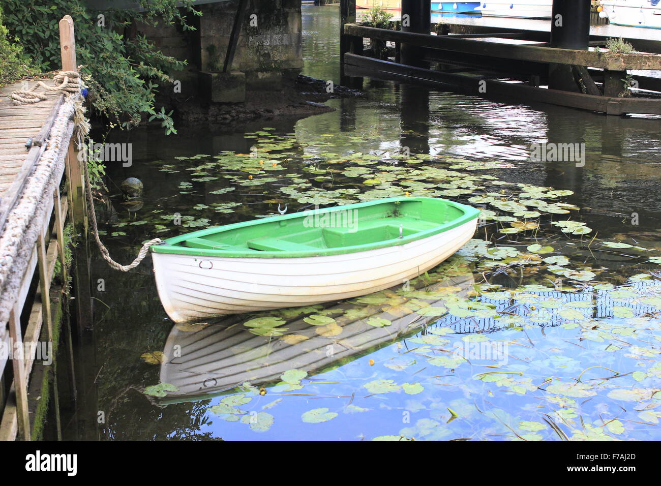Boat on water and lily pads Stock Photo Alamy