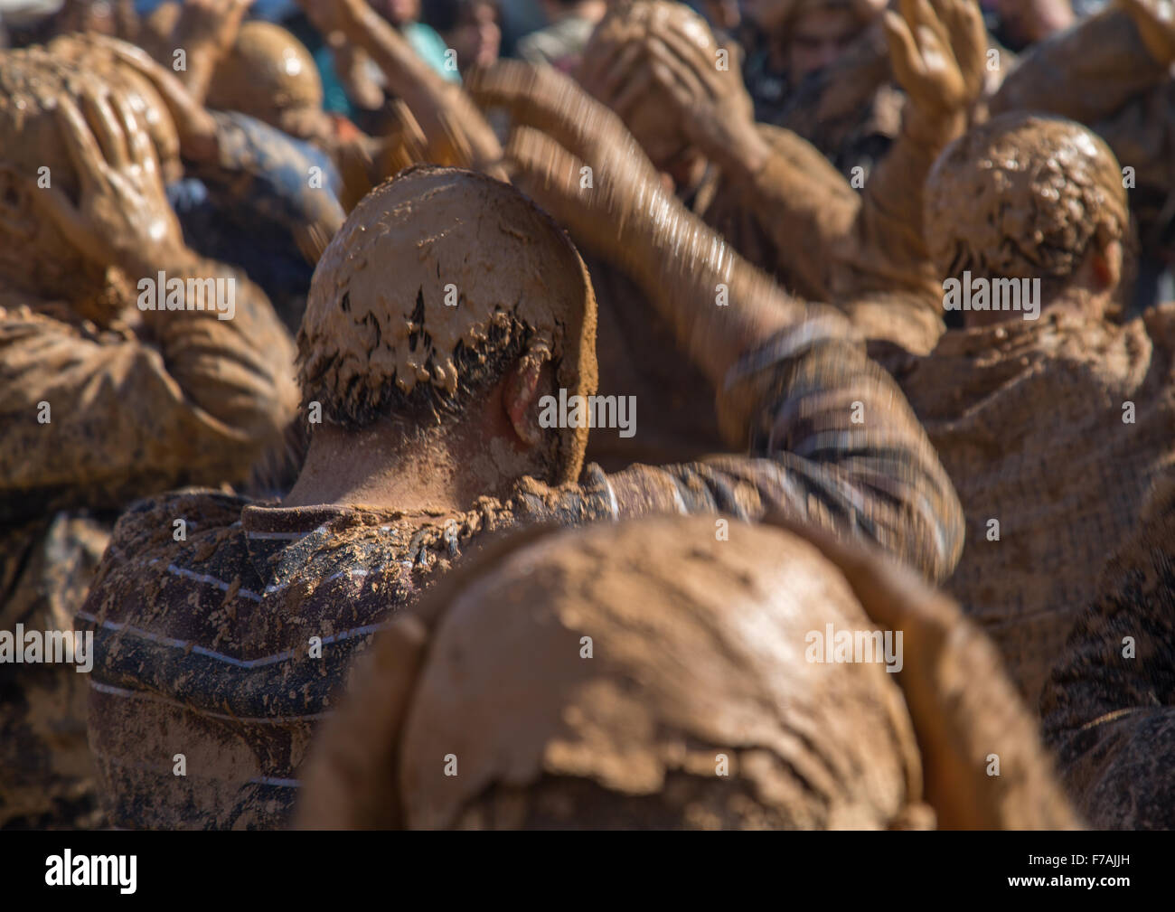Iranian Shiite Muslim Men Covered In Mud, Chanting And Self-flagellating During Ashura Day, Kurdistan Province, Bijar, Iran Stock Photo