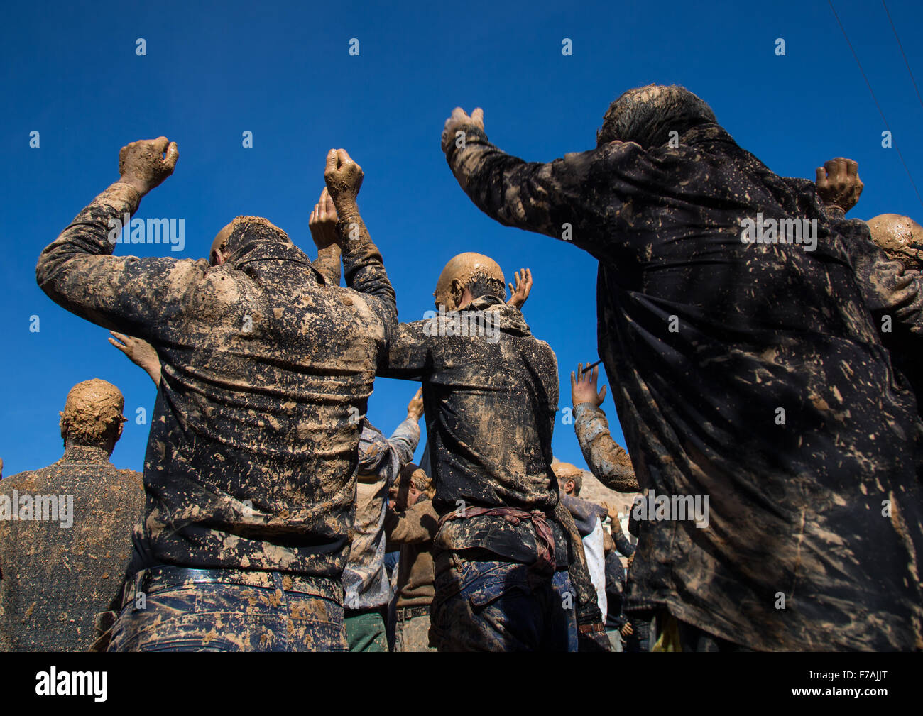 Iranian Shiite Muslim Men Covered In Mud, Chanting And Self-flagellating During Ashura, The Day Of The Death Of Imam Hussein, Kurdistan Province, Bijar, Iran Stock Photo