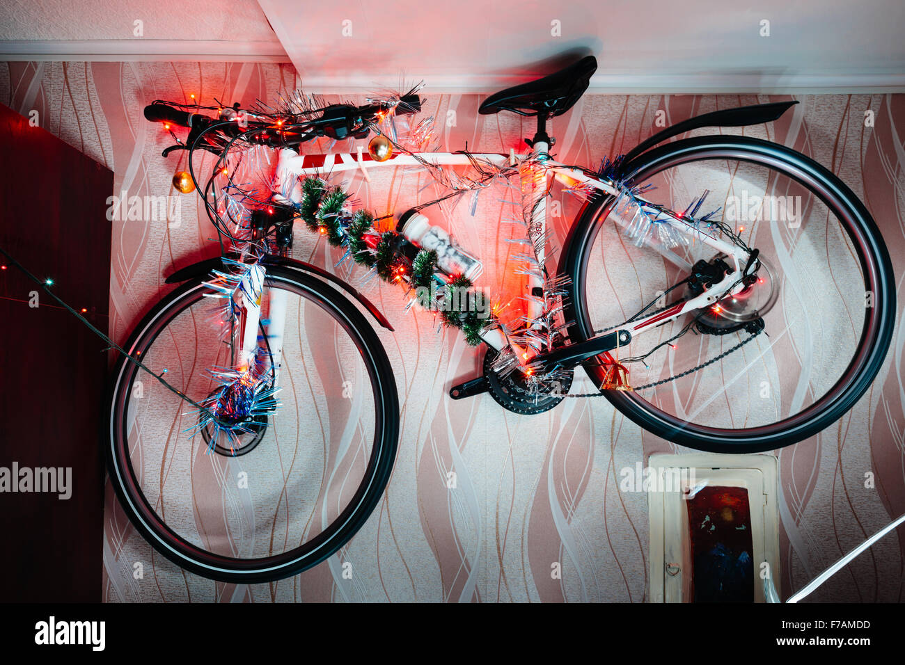 Bicycle on a wall decoration of the christmas lamp garland Stock Photo