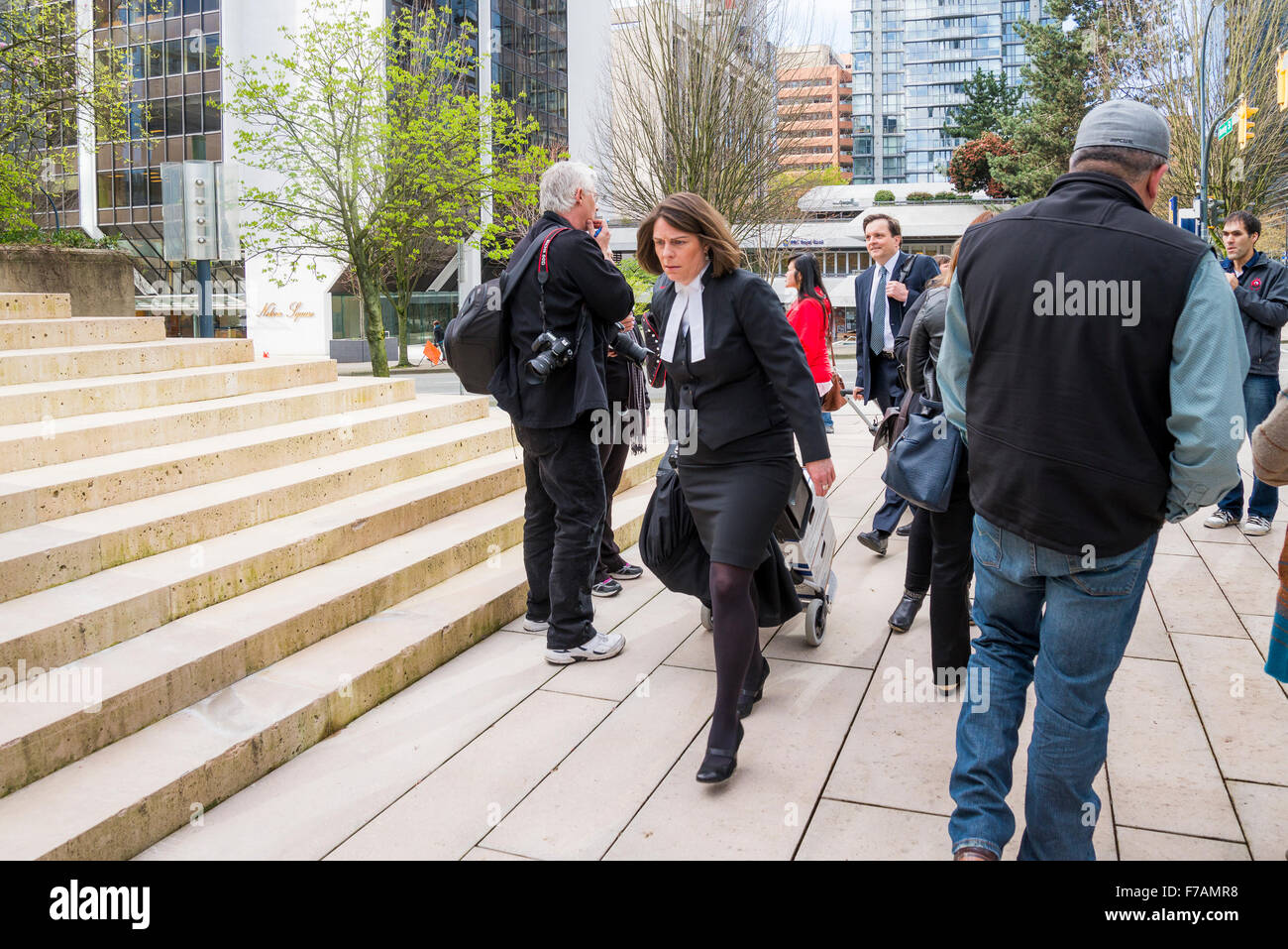 Lawyers pass through crowd outside court house, Vancouver, British Columbia, Canada Stock Photo