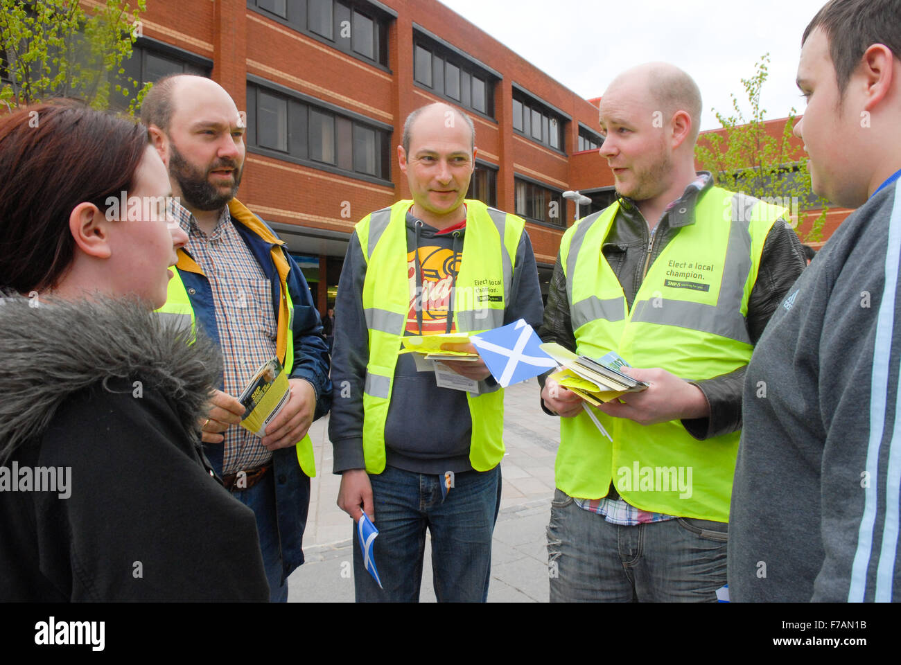 Scottish National Party (SNP) activists speak to voters in Glasgow. Stock Photo