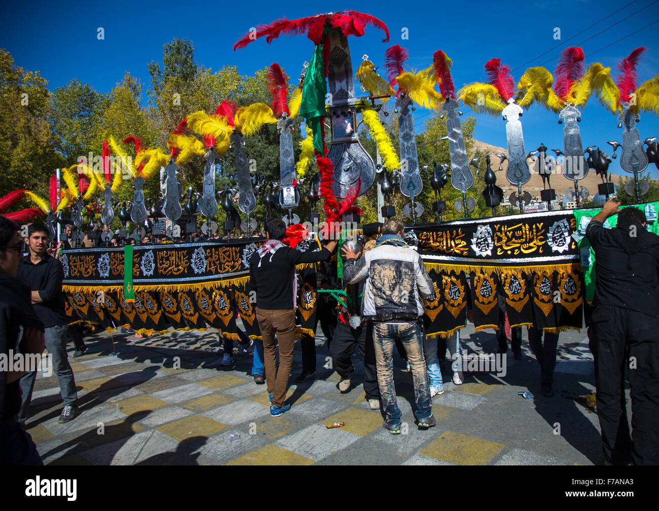 An Iranian Man Carries An Alam Is Helped By Shiite Muslim Mourners To Keep His Balance On Ashura, The Day Of The Death Of Hussein, Kurdistan Province, Bijar, Iran Stock Photo