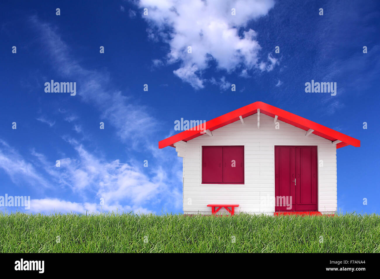 Wooden prefabricated house on the grass and the blue sky in the background Stock Photo