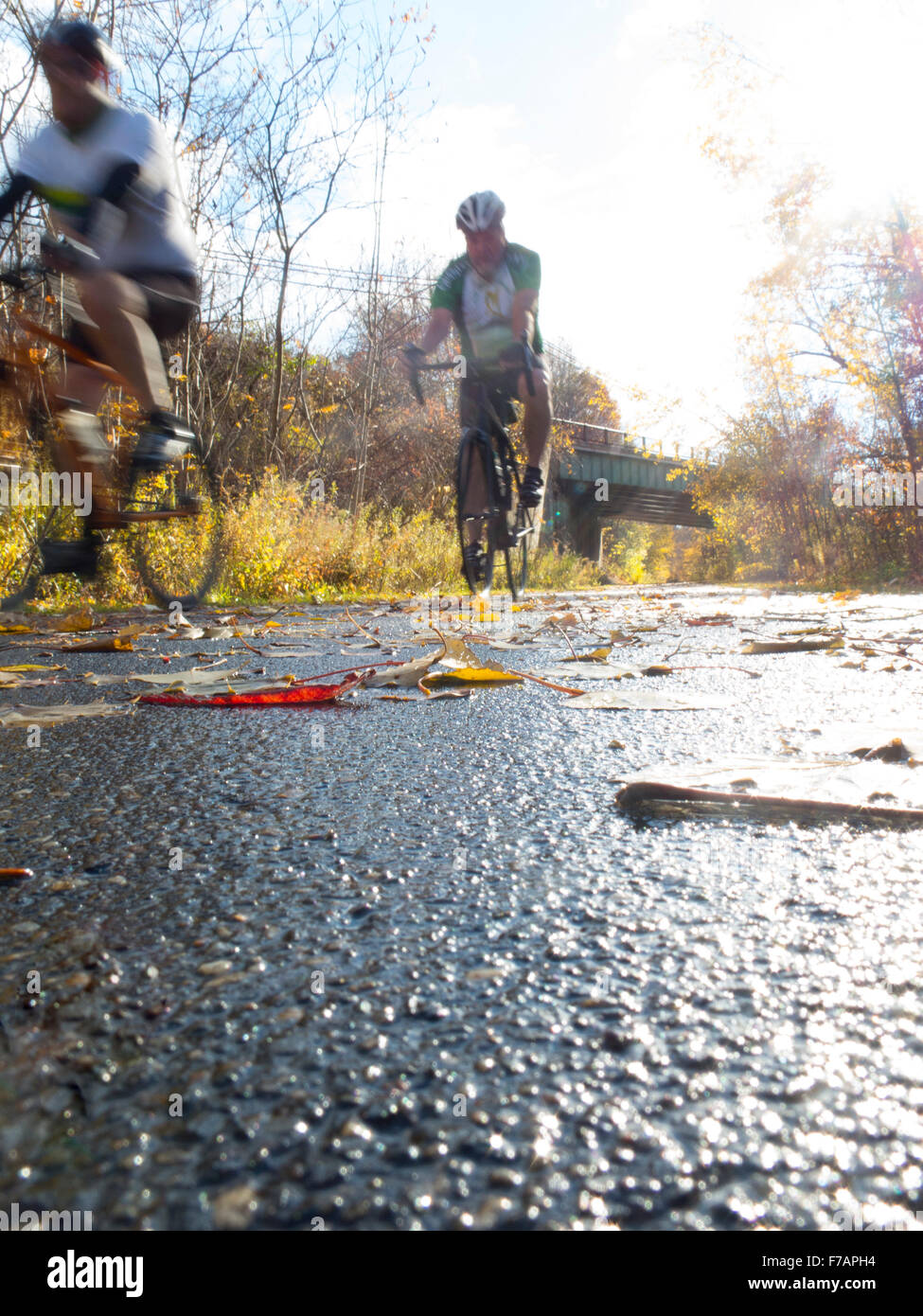 Bicyclists ride along a wet bike trail in Adams, Massachusetts. Stock Photo