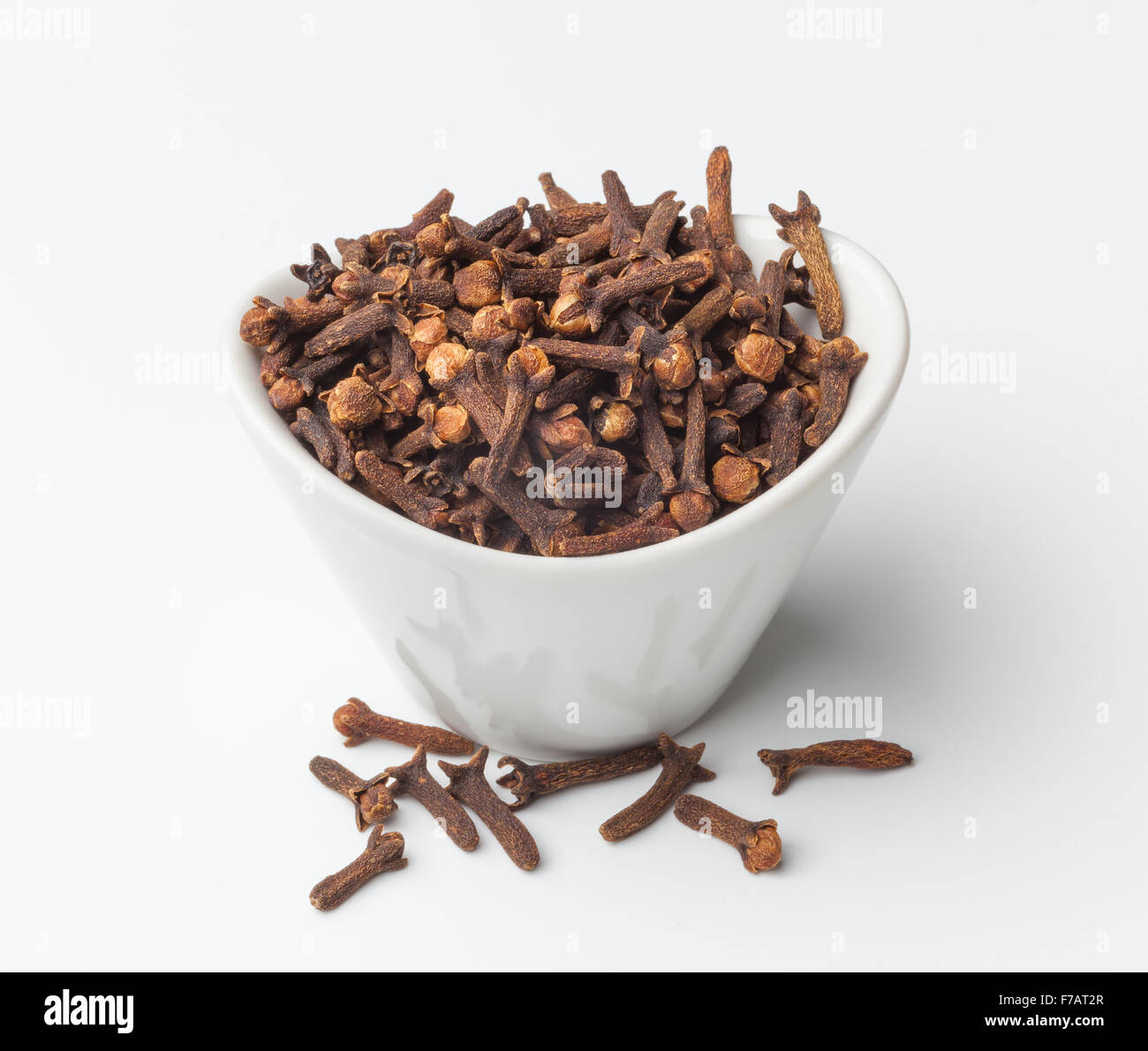 Dried cloves in a bowl, isolated on white background Stock Photo Alamy