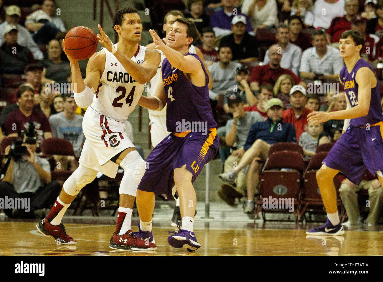Columbia, SC, USA. 27th Nov, 2015. Michael Carrera (24) of the South Carolina Gamecocks looks to pass under pressure from Garrison Mathews (14) of the Lipscomb Bisons in the NCAA Basketball match-up between the Lipscomb Bisons and the South Carolina Gamecocks at Colonial Life Arena in Columbia, SC. Scott Kinser/CSM/Alamy Live News Stock Photo