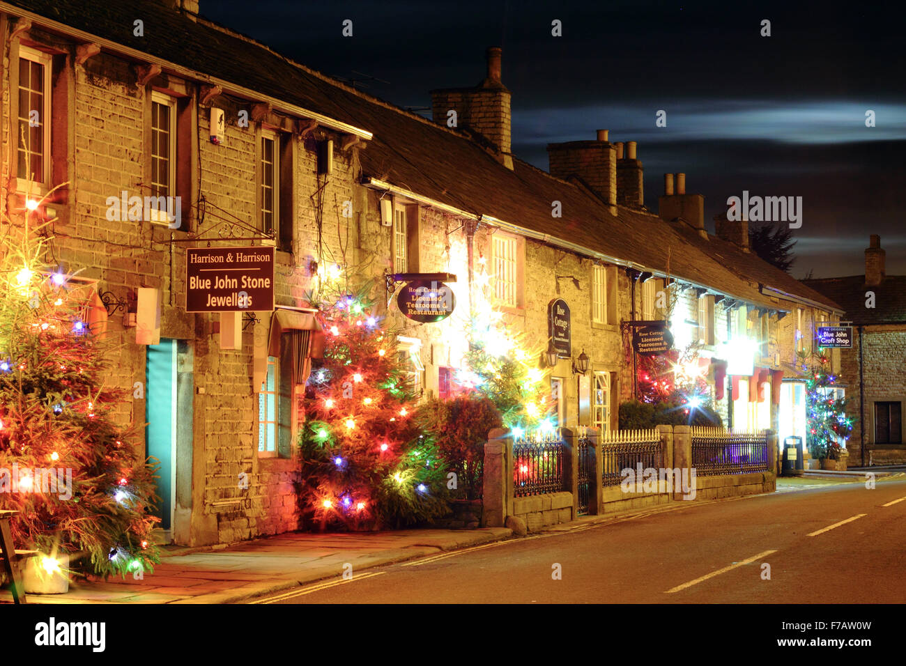 Illuminated Christmas trees line the main street in Castleton; a village in the Peak District, Derbyshire UK Stock Photo