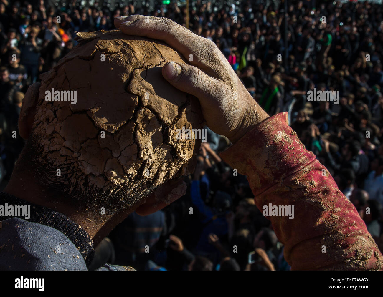 Iranian Shiite Muslim Man Covered In Mud Lokking At The Crowd During Ashura Day, Kurdistan Province, Bijar, Iran Stock Photo