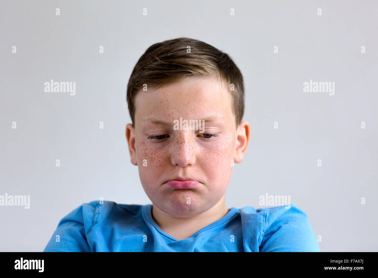 MODEL RELEASED. Boy looking grumpy, studio shot Stock Photo - Alamy