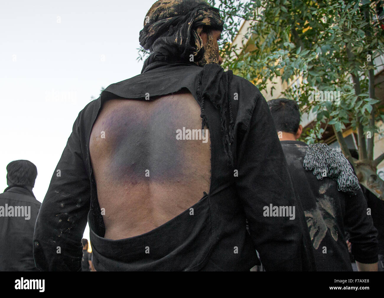 Iranian Shiite Man Covered In Mud Who Has Beaten Himself His Back With Iron Chains During Ashura, The Day Of The Death Of Imam Hussein, Kurdistan Province, Bijar, Iran Stock Photo