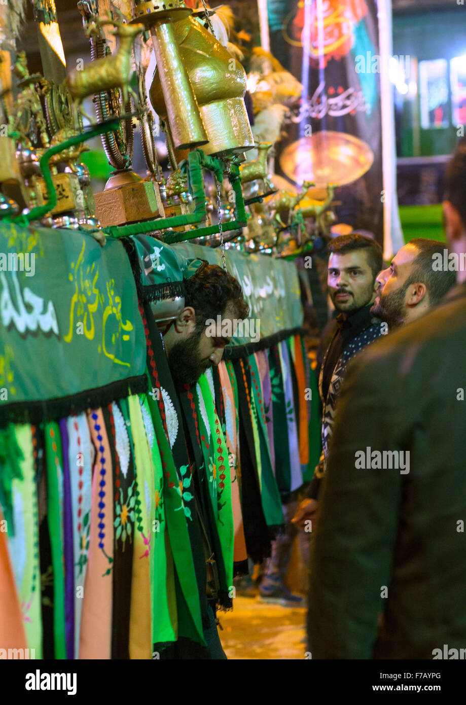 An Iranian Man Carries An Alam Is Helped By Shiite Muslim Mourners To Keep His Balance On Ashura, The Day Of The Death Of Hussein, Golestan Province, Gorgan, Iran Stock Photo