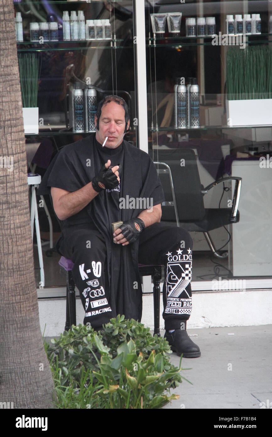 Andrew Dice Clay lights up a cigarette outside a hair salon Featuring
