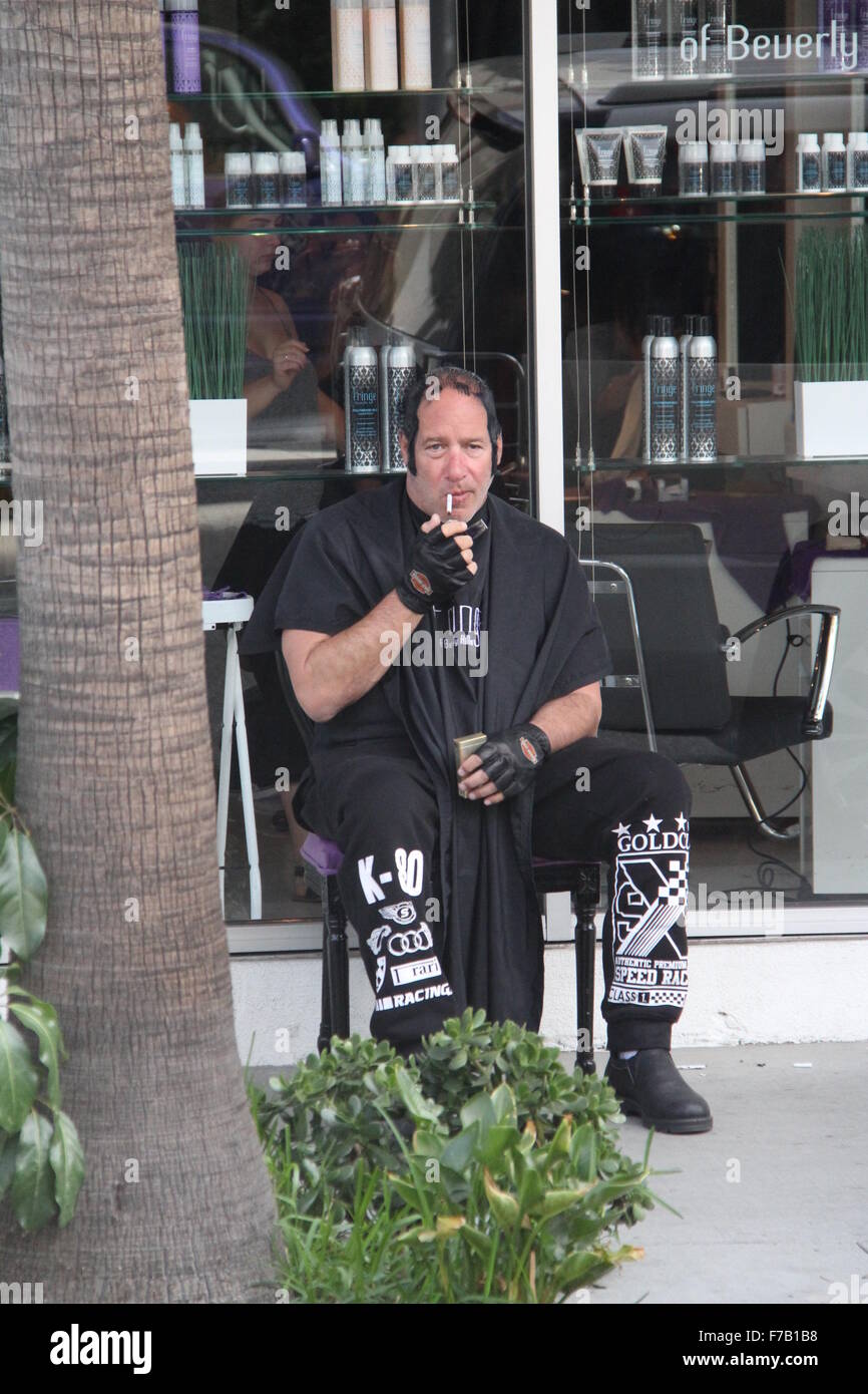 Andrew Dice Clay lights up a cigarette outside a hair salon Featuring